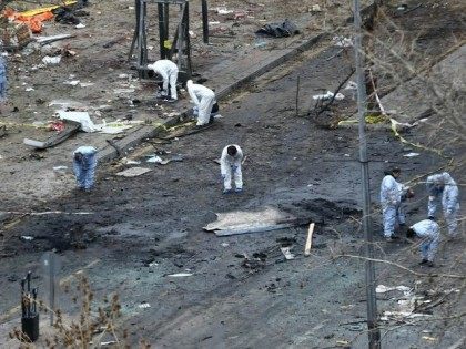 Forensic experts investigate the scene of an explosion on March 14, 2016, the day after a suicide car bomb ripped through a busy square in central Ankara killing at least 34 people and wounding 125, officials said