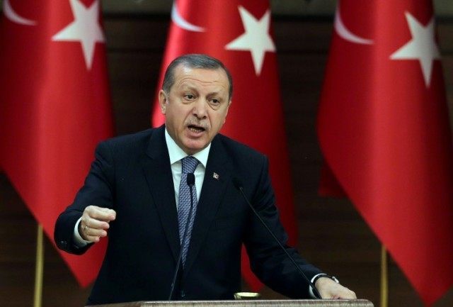 Turkish President Recep Tayyip Erdogan delivers a speech during a meeting of "mukhtars" (h