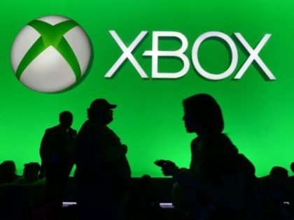 People walk past the Xbox section at the Electronic Entertainment Expo, an annual video ga