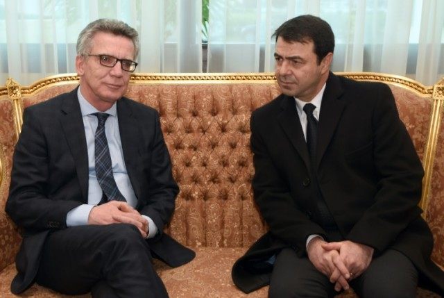 German Interior Minister Thomas de Maiziere (L) meets his Tunisian counterpart Hedi Majdou
