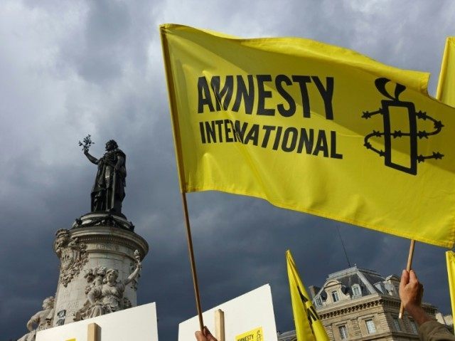 Amnesty International reports on the sufficating of over 60 men and boys in a shipping con