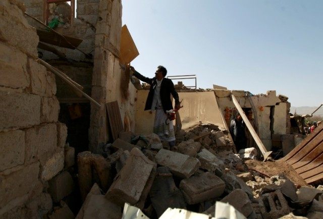 A Yemeni man checks the ruins of buildings destroyed in an air-strike by the Saudi-led coa