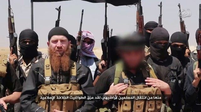 An image made available by Jihadist media outlet al-Itisam Media on June 29, 2014, allegedly shows members of the Islamic state including military leader Abu Omar al-Shishani (C-L), speaking at an unknown location