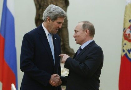 Russian President Vladimir Putin (R) speaks with US Secretary of State John Kerry during a