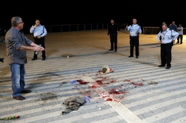 Israeli security forces stand at the scene of a stabbing attack on March 8, 2016 in the ne
