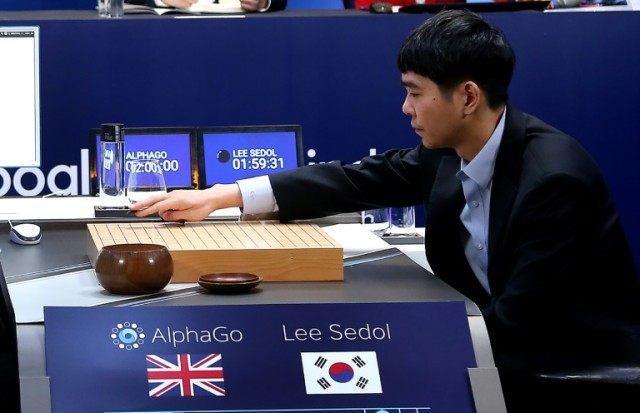Lee Se-Dol, one of the greatest modern players of the ancient board game Go, makes a move during the third game of the Google DeepMind Challenge Match against Google-developed supercomputer AlphaGo