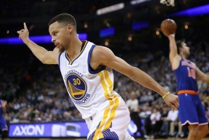 Stephen Curry of the Golden State Warriors celebrates after making a basket during their NBA game against the New York Knicks, at ORACLE Arena in Oakland, California, on March 16, 2016