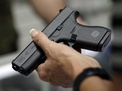 Sally Abrahamsen, of Pompano Beach, Fla., right, holds a Glock 42 pistol while shopping for a gun at the National Armory gun store and gun range, Tuesday, Jan. 5, 2016, in Pompano Beach, Fla. President Barack Obama unveiled his plan Tuesday to tighten control and enforcement of firearms in the …