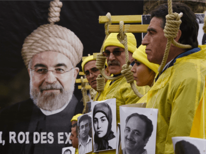 People hold placards displaying portaits as they take part in a demonstration denouncing Iran's use of the death penalty on January 28, 2016 in Paris, organised to coincide with the official visit to France by the Iranian President.