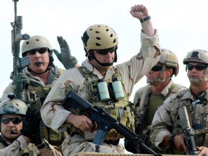 U.S. Navy SEAL Team 18 members react in recognition of contributions of former SEALS after