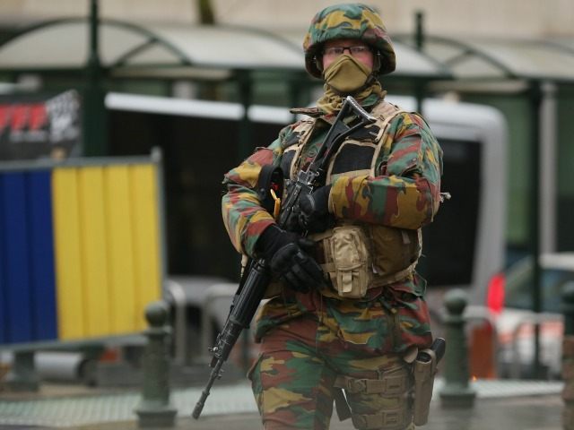n armed soldier patrols near the EU Commission Headquarters in after yesterday's terrorist attacks on March 23, 2016 in Brussels, Belgium. Belgium is observing three days of national mourning after 34 people were killed in a twin suicide blast at Zaventem Airport and a further bomb attack at Maelbeek Metro …