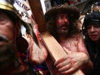 American Christian pilgrims re-enact the crucifixion of Jesus along the Via Dolorosa, the route tradition says Jesus carried the cross on which he was to be crucified by the Romans, during the Good Friday procession on April 2, 2010 in Jerusalem's Old City.