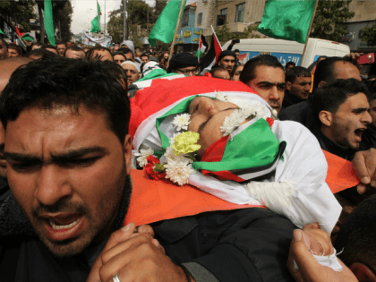 Mourners carry the body of Qassem Abu Ouda, a Palestinian who was shot dead following reported attacks on Israelis, during his funeral on March 15, 2016 in the West Bank town of Hebron.