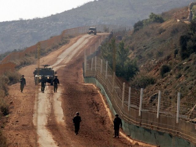 Israeli soldiers patrol the Israeli-Lebanese border at the blue line near the southern Leb
