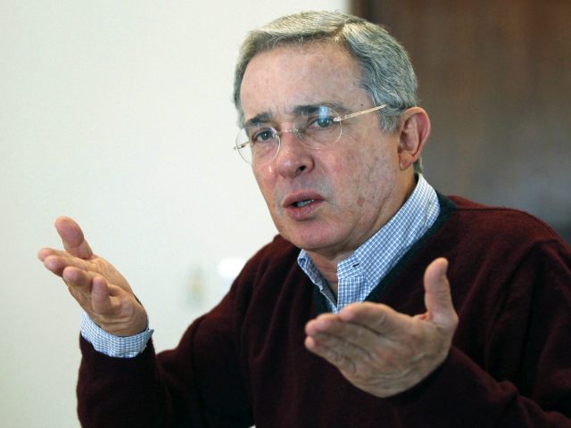 In this Feb. 9, 2013 photo, Colombia's former President Alvaro Uribe gestures during an interview in Bogota, Colombia. Uribe’s high-profile role in what has become a fierce battle for this Andean nation’s future has drawn new scrutiny to his ties to provincial politicians, military officers and landowners accused of backing …