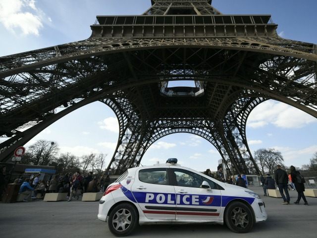 A police car is parked near the Eiffel tower, on March 22, 2016 in Paris.