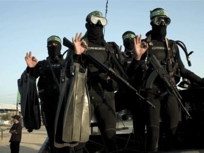 Palestinian youth pose for a picture during a military-style camp organized by the Hamas m