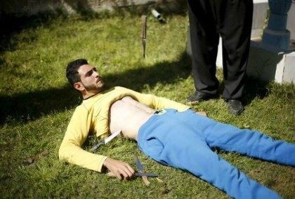 Palestinian Mohammad Baraka has knives dropped on his stomach as he exercises in Deir al-B