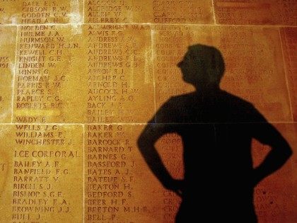 The shadow of a man is cast upon some of over 72,000 names carved on the Thiepval memorial