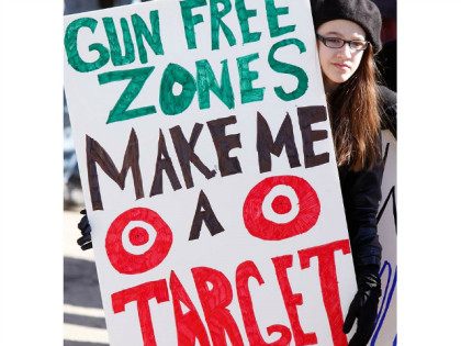 Emma Solorzano, 13, of Jefferson, holds a sign saying Gun Free Zones Make Me a Target at a rally protesting gun control legislation and supporting gun rights in Wiscasset on Saturday, March 9, 2013, About 175 people attended the rally, which was organized by Jessica Beckwith of Lewiston, who is …