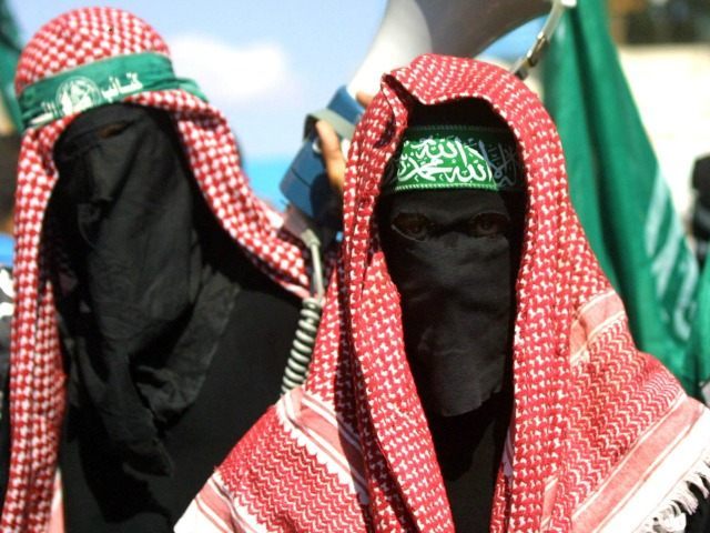 Masked members of the Islamic militant Hamas group march in the Jabalya refugee camp to protest against the U.S. position on Jerusalem October 4, 2002 in northern Gaza Strip.