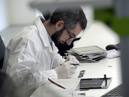 A technician repairs a tablet on November 7, 2014 at the 'Allo Smartphone' company in Paris. The company collects and repairs all kind of smartphones before bringing them to the market.