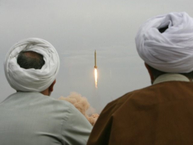 ranian clergymen watch a Shahab-3 long-range ballistic missile fird by Iran's Revolut