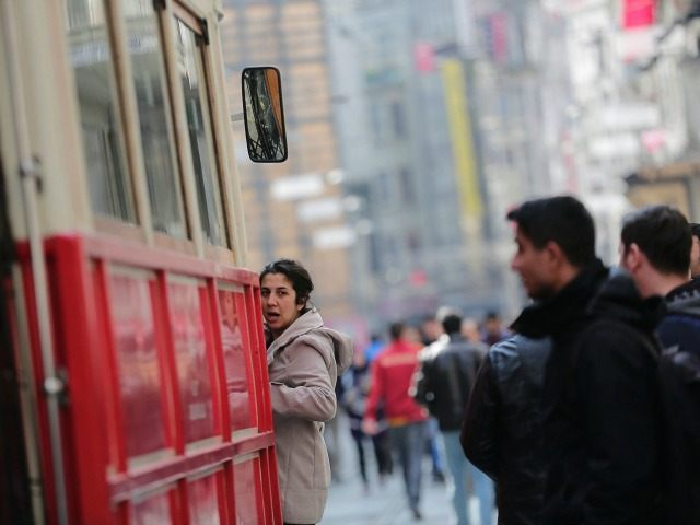 A woman enters a tramway on Istiklal Street, a major shopping and tourist district, in cen