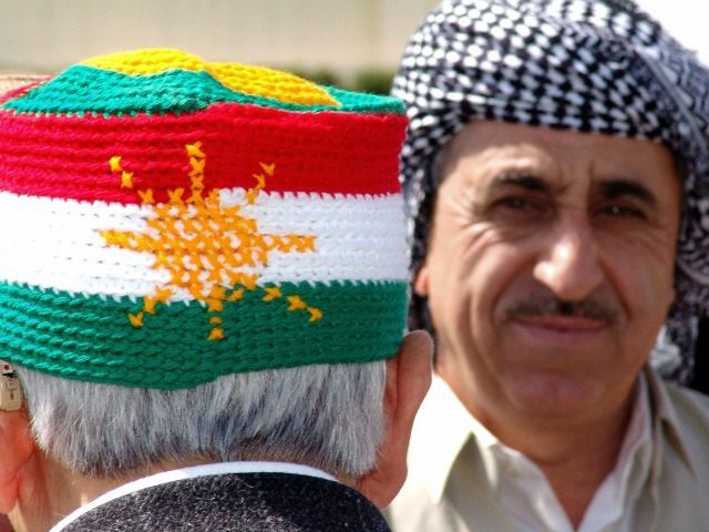 Kurdish man wears a knitted hat with the Kurdish national flag during a memorial festival
