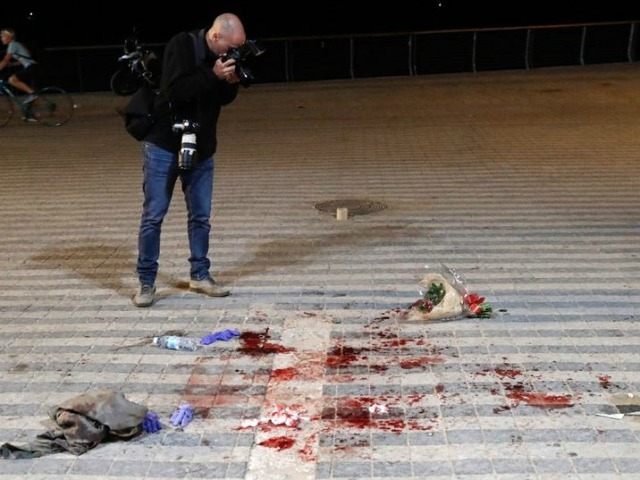 A photographer takes pictures at the scene of a stabbing attack in the neighbourhood of Ja