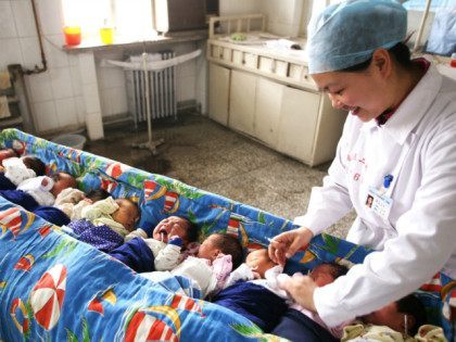ZHANGJIAKOU, CHINA - OCTOBER 01: (CHINA OUT) A nursing worker takes care of new-born babies at the Second Affiliated Hospital of Hebei North University on October 1, 2015 in Zhangjiakou, Hebei Province of China. China has decided to abandon its 35-year-old one-child policy, allowing all couples to have two children, …