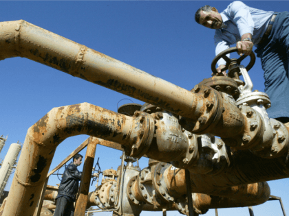 File picture dated 19 January 2004 shows Iraqi workers turning valves at the Shirawa oilfield, where oil was first pumped in Iraq in 1927, outside the northern Iraqi city of Kirkuk.