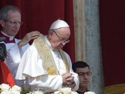 Pope Francis (C) prepares to deliver the 'Urbi et Orbi' blessing for Rome and th