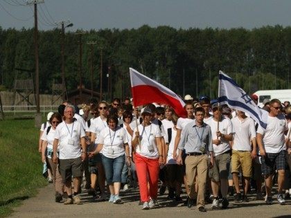 Participants carry Polish, German and Israeli flags, as they take part in the 'March