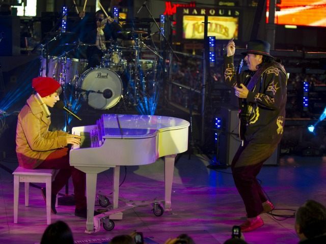 Justin Bieber and Carlos Santana perform during the New Year's Eve celebration in Times Square December 31, 2011 in New York.