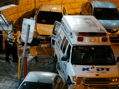 Israeli rescuers remove a body from the scene of a shooting attack in East Jerusalem's Salahedin street following on March 8, 2016. A Palestinian shot and seriously wounded two Israeli police officers in Jerusalem before being shot dead,