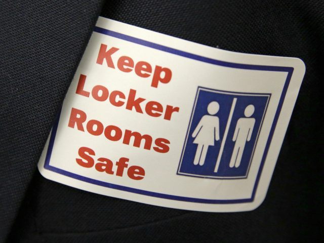 FILE - In this Jan. 27, 2016 file photo, a sticker that reads, "Keep Locker Rooms Safe," is worn by a person supporting a bill that would eliminate Washington's new rule allowing transgender people use gender-segregated bathrooms and locker rooms in public buildings consistent with their gender identity, at the …