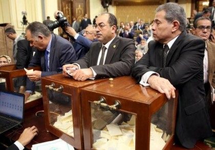 Tawfik Okasha (R), looks onvote to choose the head of the Egypt's Parliament late in