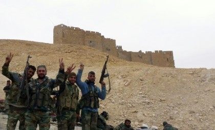 Syrian government forces wave next to the Palmyra citadel