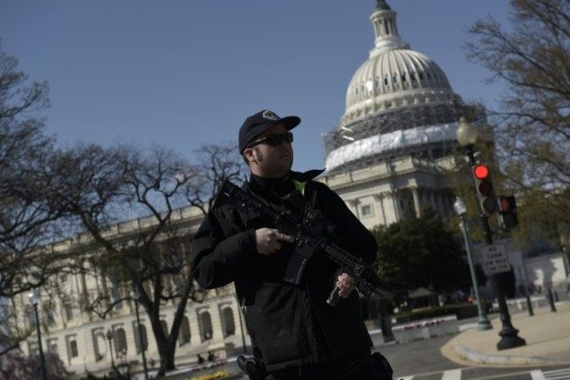 A police officer stands guard at the US Capitol complex in Washington, DC on March 28, 2016 after reports of shots fired