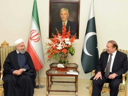 Pakistan's Prime Minister Nawaz (R) speaks with Iranian President Hassan Rouhani at the Pr