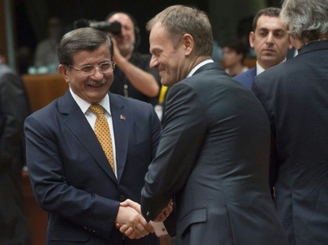 Turkey's Prime Minister Ahmet Davutoglu (L) talks with EU Council President Donald Tusk du