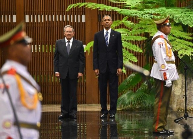 US President Barack Obama (2-L) stands next to Cuban President Raul Castro upon his arriva