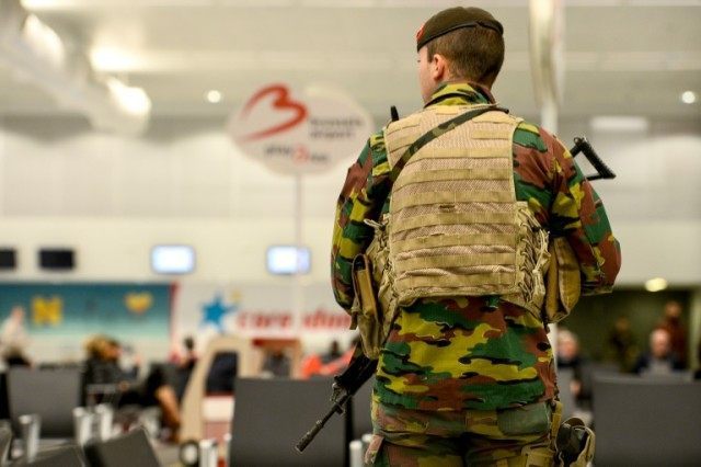 A member of military police patrols the Brussels Airport