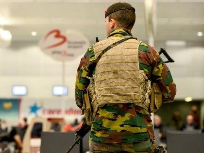 A member of military police patrols the Brussels Airport