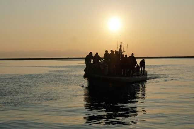 Migrants and refugees arrive aboard a Swedish Frontex patrol boat at the port of Mytilene
