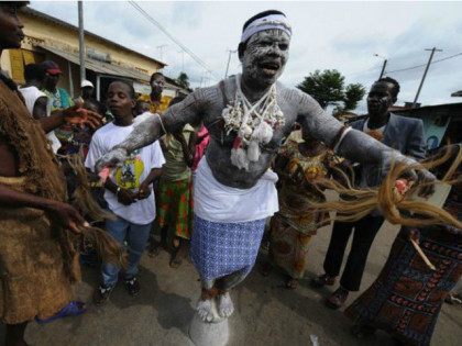 IVORY COAST, Bonoua : A witch-doctor stands on a pot on May 3, 2008 during the procession of the 30th Popo carnival of Bonoua, 60 km south of Abidjan. AFP PHOTO/ KAMBOU SIA