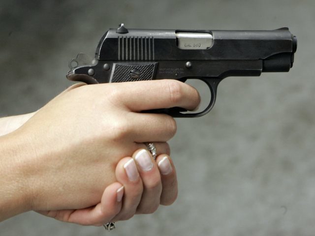 Jennifer Deasy holds her Colt Government .380 caliber pistol at the target range at Niagar
