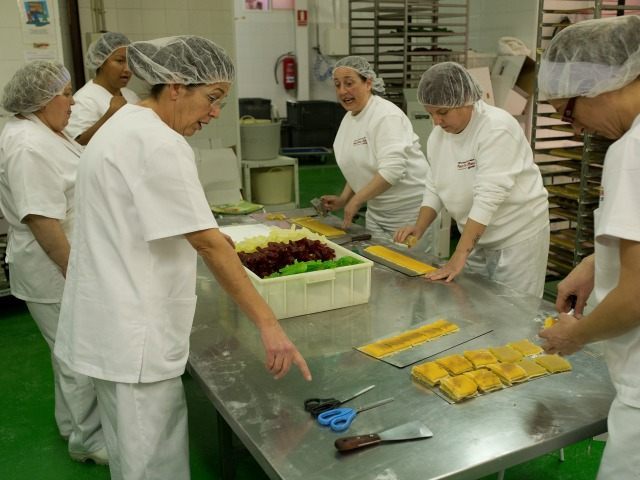 Women make 'Pan de Cadiz', a variety of turron mixed with dried fruits at the Tu