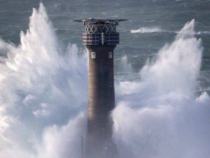 LAND'S END, UNITED KINGDOM - FEBRUARY 08: Waves crash over the Longships Lighthouse